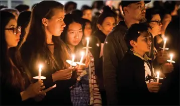 ?? LEO JARZOMB — STAFF PHOTOGRAPH­ER ?? Arcadia High students and parents attend a vigil for slain students Anthony Lin, 15, and William Lin, 16, at the Arcadia campus. Their uncle, Deyun Shu, was found guilty by an Alhambra jury of first-degree murder of the brothers Wednesday.