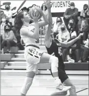  ?? Alex Eller ?? Jaide Chandler of Anselmo-Merna goes up for a layup over Brooke McCully of Mullen during the first half of their matchup on Dec. 4. Chandler led all scorers with 15 points.