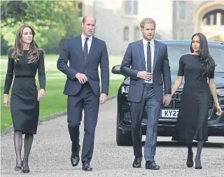  ?? ?? Prince Harry, Duke of Sussex (second from right) holds hands with Meghan, Duchess of Sussex alongside Catherine, Princess of Wales, and Prince William, Prince of Wales