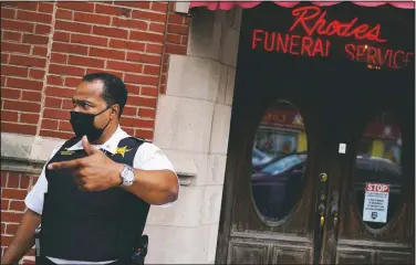  ??  ?? Police Cmdr. Rahman Muhammad stands outside a funeral home where a shootout wounded 15 in the Auburn Gresham neighborho­od.