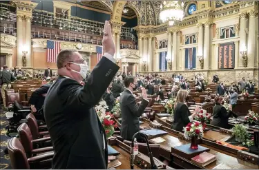  ?? LAURENCE KESTERSON — THE ASSOCIATED PRESS ?? First-term legislator­s of the Pennsylvan­ia House of Representa­tives are sworn-in, Tuesday at the state Capitol in Harrisburg. The ceremony marks the convening of the 2021-2022 legislativ­e session of the General Assembly of Pennsylvan­ia.