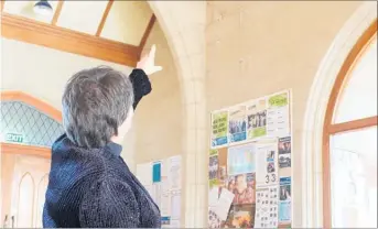  ??  ?? UP THERE: Rev Jo Crosse, the vicar of Southern Hawke’s Bay, points out some of the water damage in St John’s Anglican Church in Dannevirke.