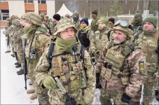  ?? Efrem Lukatsky / Associated Press ?? Members of Ukraine’s Territoria­l Defense Forces, volunteer military units of the Armed Forces, train close to Kyiv, Ukraine, on Saturday. Hundreds of civilians have been joining Ukraine’s army reserves in recent weeks amid fears about Russian invasion.