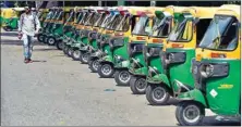  ??  ?? A man walks in front of auto-rickshaws seen parked along a road, during transport strike in New Delhi, on Thursday