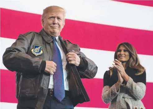  ??  ?? PATRIOT: US President Donald Trump dresses for the occasion as he prepares to address US soldiers, with wife Melania watching.