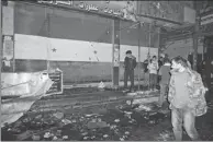  ?? XINHUA ?? People check the market in Damascus after it was hit by a rocket on Tuesday. Thirty-five people were killed, making it one of the deadliest attacks in the capital in the seven-year civil war.