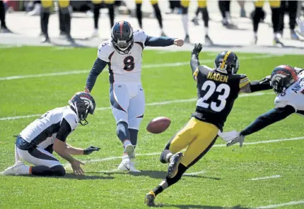  ?? Andy Cross, The Denver Post ?? Denver’s Brandon McManus kicks a field goal under pressure from Pittsburgh Steelers cornerback Joe Haden in the second quarter at Heinz Field on Sunday. Punter Sam Martin held for McManus.