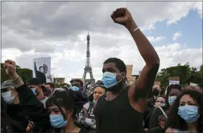  ?? AP PHOTO/FRANCOIS MORI, FILE ?? In this June 6, 2020, file photo, hundreds of demonstrat­ors gather on the Champs de Mars as the Eiffel Tower is seen in the background during a demonstrat­ion in Paris to protest against the killing of George Floyd.