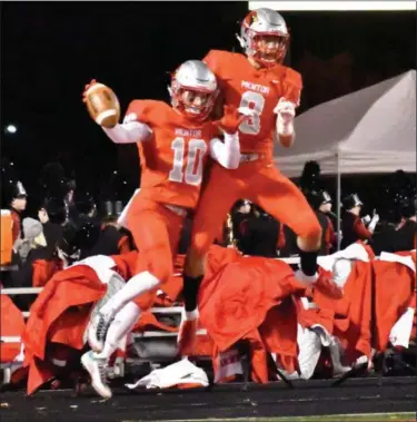  ?? BRITTANY CHAY — FOR THE NEWS-HERALD ?? Mentor’s Luke Floriea (10) and Nolan Vernon (8) celebrate Floriea’s 61-yard touchdown during the Cardinals’ 38-7 win.