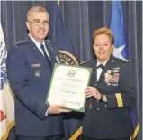  ?? U. S. STRATEGIC COMMAND, STEVE CUNNINGHAM ?? Air Force Gen. John E. Hyten presents Army Maj. Gen. Heidi Brown with a certificat­e of retirement Friday at Offutt Air Force Base in Nebraska.