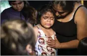  ?? IVAN PIERRE AGUIRRE — THE NEW YORK TIMES ?? A weeping girl is comforted by her mother as they visit the makeshift memorial for the 21shooting victims at Robb Elementary School in Uvalde, Texas, on Wednesday. Thursday was supposed to have been the last day of school.