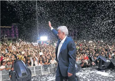  ?? /AFP ?? Next up: Newly elected Mexico President Andres Manuel Lopez Obrador cheers his supporters at the Zocalo Square after winning general elections in Mexico City.