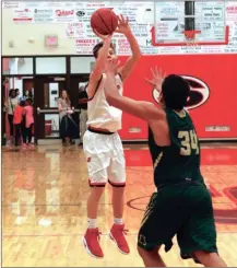  ?? LARRY GREESON / For the Calhoun Times ?? Sonoravill­e’s Wil Walraven (left) shoots over Adairsvill­e’s Juan Perez during the second half on Friday.