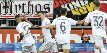  ?? AP PHOTO/MARTIN MEISSNER ?? Bayern’s Robert Lewandowsk­i (2nd from left) is celebrated after scoring the opening goal during the German Bundesliga soccer match between 1. FC Cologne and Bayern Munich in Cologne, Germany, on Sunday.