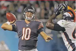  ?? | JONATHAN DANIEL/ GETTY IMAGES ?? Trubisky, passing under pressure fromthe Broncos’ Shakir Soto on Thursday night, finished 18- for- 25 for 166 yards and one TD.