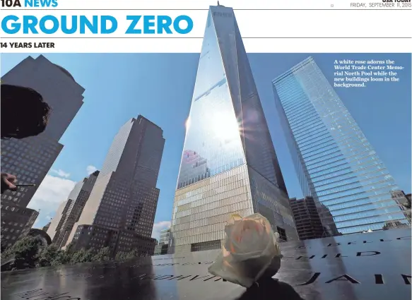  ?? JOHN G. MABANGLO, EUROPEAN PRESSPHOTO AGENCY ?? A white rose adorns the World Trade Center Memorial North Pool while the new buildings loom in the background.