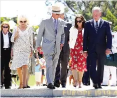  ??  ?? PERTH: Britain’s Prince Charles (C) and his wife Camilla, Duchess of Cornwall (L) pay their respects with West Australian Premier Colin Barnett (R) at the Flame of Remembranc­e during a visit to Kings Park in Perth. — AFP