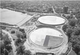  ?? JERRY JACKSON/BALTIMORE SUN ?? Two water storage tanks nearing completion will hold more than 50 million gallons of drinking water undergroun­d at west end of the lake in Druid Hill Park.