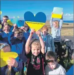  ?? ?? Kilmuir Primary School pupils show their support for Ukraine with blue and yellow paper hearts.