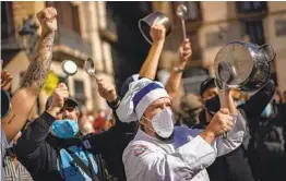  ?? EMILIO MORENATTI AP ?? Workers of catering sectors take part in a protest of virus restrictio­ns organized by restaurant­s and bar owners in Barcelona, Spain, on Friday.