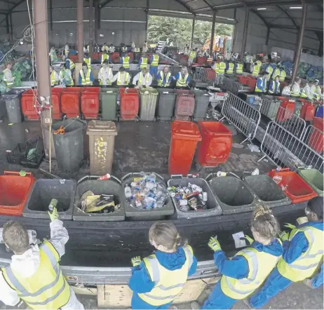  ?? ?? ↑ Collected rubbish is processed at the Glastonbur­y Festival’s purposebui­lt recycling centre after festival-goers have left the site at Worthy Farm