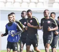  ??  ?? Qatar team during a warm-up ahead of their match against North Korea on Sunday.