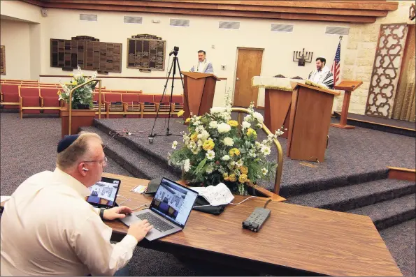  ?? Christian Abraham / Hearst Connecticu­t Media ?? Because of the ongoing coronaviru­s pandemic, Fred Knopf runs Congregati­on B’nai Torah’s Rosh Hashanah holiday service via livestream in Trumbull on Friday.