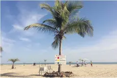  ?? THE ASSOCIATED PRESS ?? Tourists relax on the beach in Banjul.