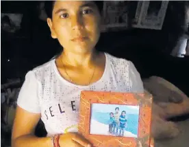  ?? CORTESÍA ?? Yuliana Sanguino con la foto de su hijo desapareci­do hace dos años en Minca.