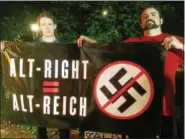  ?? EVAN BRANDT — DIGITAL FIRST MEDIA ?? Justin Dion, left, drove up from Silver Spring Maryland to help his friend Chris Brickhouse, seen here holding a banner he brought to the rally, organize Friday night’s events.