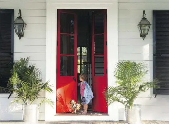  ?? PHOTO COURTESY OF BENJAMIN MOORE ?? Painting a front door red — in this case,, Benjamin Moore’s Dutch Tulip shade — adds an immediate robust, punchy tone to a home’s exterior.