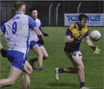  ??  ?? First-half goalscorer Ben Brosnan about to claim possession after the break as Michael Kiely moves in.