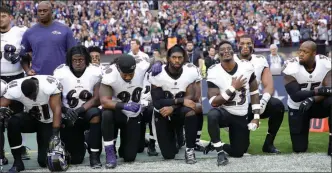  ?? The Associated Press ?? Baltimore Ravens players kneel during the playing of the U.S. national anthem before an NFL football game against the Jacksonvil­le Jaguars at Wembley Stadium in London, Sunday.