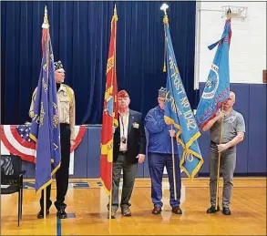  ?? Immaculate High School / Contribute­d photo ?? Veterans hold flags at Immaculate High School’s ceremony honoring Veterans Day.