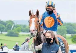  ?? Picture: PA. ?? Left: Serpentine and Emmet McNamara pull well clear to win the Investec Derby; above: Oaks winner Love, with Ryan Moore aboard, is led into the winner’s enclosure.