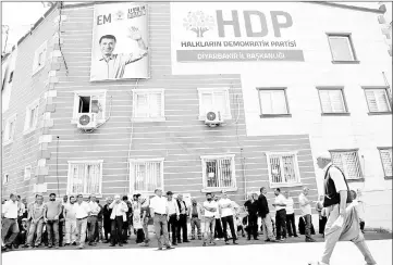  ??  ?? People gather outside the headquarte­rs of pro-Kurdish Peoples’ Democratic Party (HDP) during an election campaign in Diyarbakir.