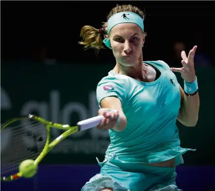  ?? Determinat­ion: ?? Svetlana Kuznetsova of Russia makes a forehand return to Agnieszka Radwanska of Poland during their match in the WTA Finals at the Singapore Indoor Stadium yesterday. — AP