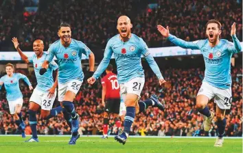  ?? Rex Features ?? David Silva of Manchester City (centre) celebrates scoring opening goal with teammates during a Premier League match against Manchester United earlier this month.