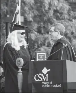  ?? SUBMITTED PHOTOS ?? CSM Professor Sandy Poinsett, winner of the Faculty Excellence Award, is congratula­ted by Faculty Senate President Mike Green at the college’s 58th spring commenceme­nt ceremony May 18.