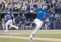  ?? Mark Blinch The Canadian Press ?? EDWIN ENCARNACIO­N of the Blue Jays excitedly runs to first base after his two-run single in the seventh inning.