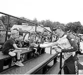  ?? Jeffrey Phelps, The Associated Press ?? Alex Palou celebrates by giving a child a signed cap after winning an Indycar race at Road America.