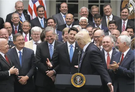  ?? Mark Wilson / Getty Images ?? President Trump congratula­tes House Republican­s at the White House after their health care legislatio­n passed on Thursday.