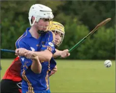  ??  ?? Conor Hughes of Ballinastr­agh Gaels about to strike despite pressure from Declan Sinnott (Oulart-The Ballagh).