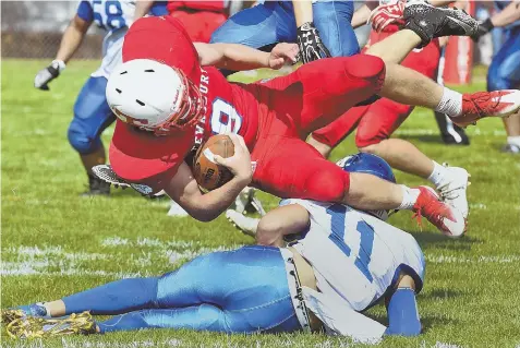  ?? STAFF PHOTOS BY PATRICK WHITTEMORE ?? PRETTY PICKED OFF: Methuen quarterbac­k Jordan Perdomo (11) tackles Tewksbury’s Brandon Winn after Winn intercepte­d Perdomo’s pass during the second quarter of yesterday’s showdown in Tewksbury.