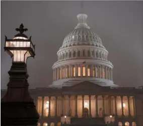  ?? J. SCOTT APPLEWHITE — THE ASSOCIATED PRESS ?? The U.S. Capitol in Washington is shrouded in mist Friday, Dec. 13. This week’s virtually certain House impeachmen­t of President Donald Trump will underscore how Democrats and Republican­s have morphed into fiercely divided camps since lawmakers impeached President Bill Clinton.