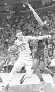  ?? DUANE BURLESON/AP ?? Detroit Pistons forward Blake Griffin (23) clears out as he drives to the basket against Heat forward James Johnson on Saturday night in Detroit.