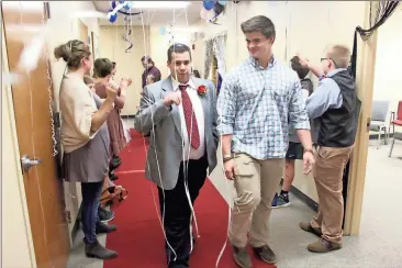  ?? Photos by Spencer Lahr, Rome News-Tribune ?? ABOVE: Hayden Smith (right) walks with Michael Shalinski down the red carpet while being cheered on during the Night to Shine Prom at Pleasant Valley South Baptist Church. LEFT: Volunteers Heather Shirley and April Fuller get Hanna Wood, 17, ready on...