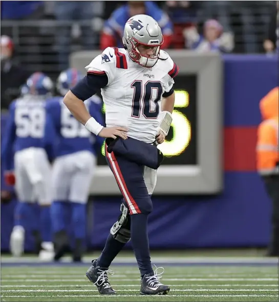  ?? ADAM HUNGER — THE ASSOCIATED PRESS ?? New England Patriots quarterbac­k Mac Jones (10) walks off the field after throwing an intercepti­on against the New York Giants during the second quarter of an NFL football game, Sunday, Nov. 26, 2023, in East Rutherford, N.J.