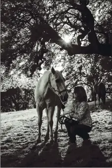  ?? PHOTO BY NATHAN DEHART ?? Author Michelle Scully and her horse Simba.