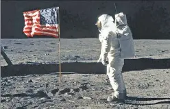  ??  ?? Symbol of victory: The American flag stands proudly on the lunar surface, with astronaut Buzz Aldrin nearby, on July 20, 1969.